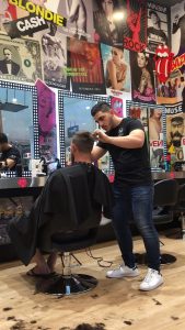 Ali cutting hair as an apprentice in 2016. 